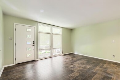 Unfurnished room with dark wood-style flooring an