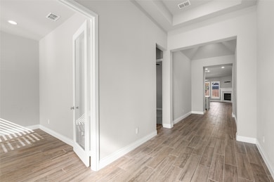 Corridor with recessed lighting and wood tiled floors
