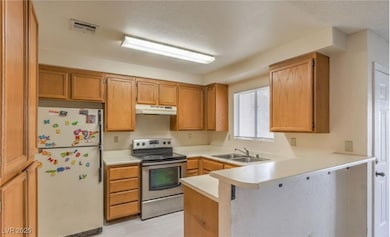 Kitchen with freestanding refrigerator, stainless