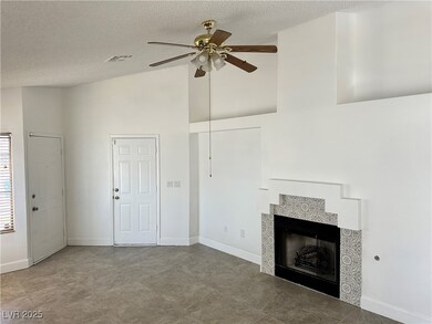 Unfurnished living room featuring a ceiling fan, a