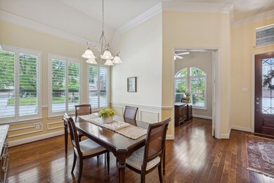 Dining room with ceiling fan with notable chandeli