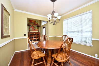 Just to the left of the foyer is the formal dining room. With ample space for a table that easily accommodates friends and family, this is the space you will love serving special meals all holiday season. Rich wood plank flooring, crown molding, charming light fixture, chair rail and 2” blinds on the windows wrap up this room.
