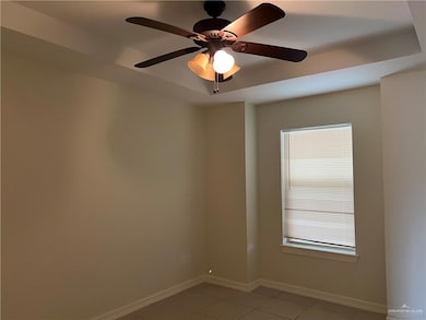 Tiled spare room with ceiling fan and a wealth of natural light
