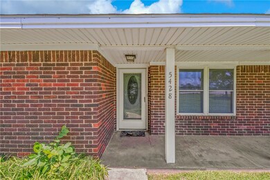 Doorway to property with brick siding