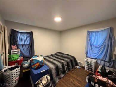 Bedroom with dark wood-type flooring