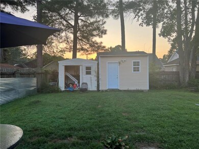 Back yard view at sunset 2 sheds to remain