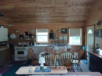 Dining space with wood walls, lofted ceiling, and 