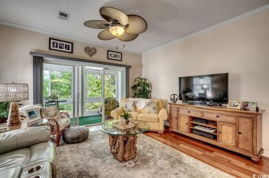 Living room featuring ceiling fan, a textured ceil