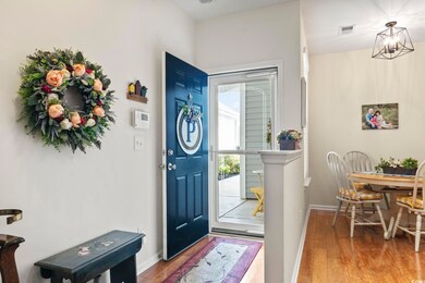Entryway with an inviting chandelier and hardwood 