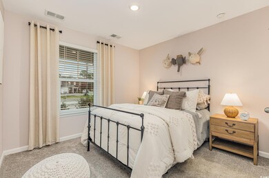 Carpeted bedroom with baseboards