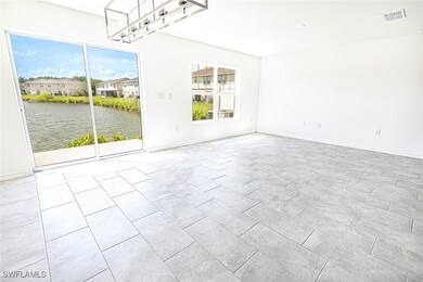 Empty room with baseboards, visible vents, and a w