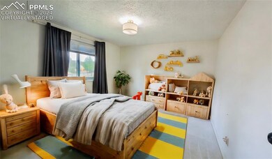 Bedroom with a textured ceiling and carpet floors 