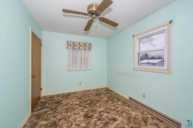 Carpeted bedroom with ceiling fan