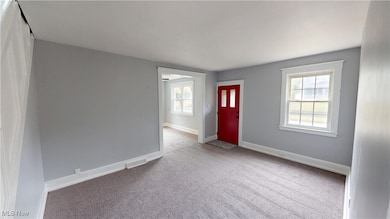 Carpeted foyer with healthy amount of natural light