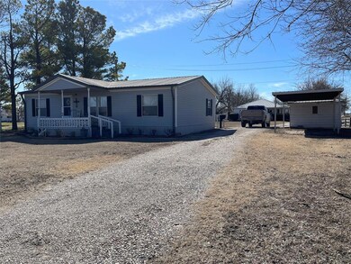 View of front of property featuring a carport and 