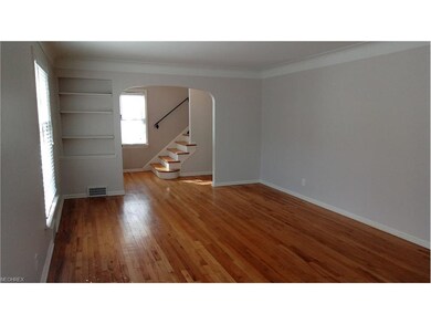 LIVING ROOM LOOKING TOWARD ENTRANCE AND STAIRCASE 