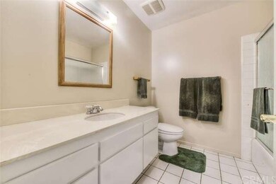 Full hall bathroom with ceramic tile flooring.