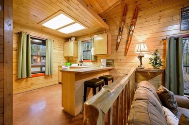 Kitchen with lofted ceiling with skylight, a wealt