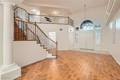 Entrance foyer with stairway, a towering ceiling,