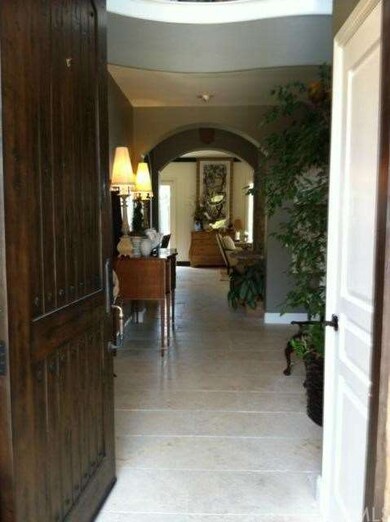 Grand entrance with custom front door and traverti