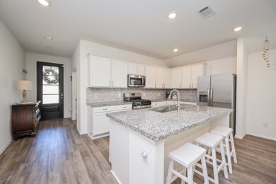 Stainless steel appliances —all sleek and modern, reinforcing the kitchen’s high-function appeal.