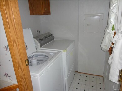 The laundry room is located just off the kitchen. 