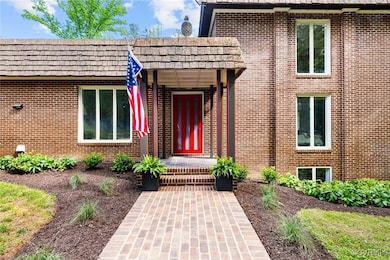 Property entrance featuring brick siding