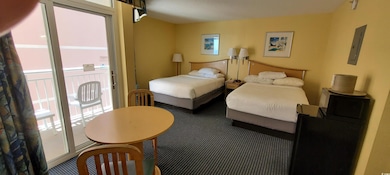 Carpeted bedroom featuring access to outside, elec