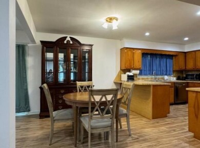 Kitchen with kitchen peninsula, sink, and light ha