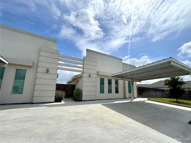 View of side of home featuring stucco siding and parking