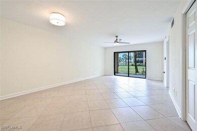 Spare room featuring ceiling fan, light tile patte