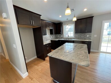 Kitchen includes granite counters and matching bac