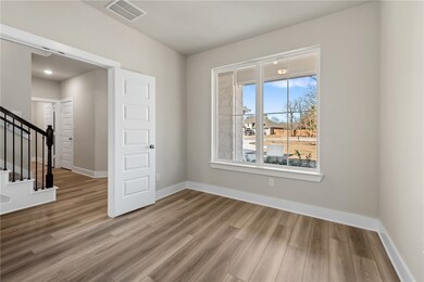 Empty room with hardwood / wood-style floors