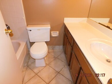 HALL BATH WITH CULTURAL MARBLE TOP, CERAMIC TILE FLOOR AND TUB SURROUND