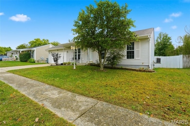 View of front of house with concrete driveway and an attached garage