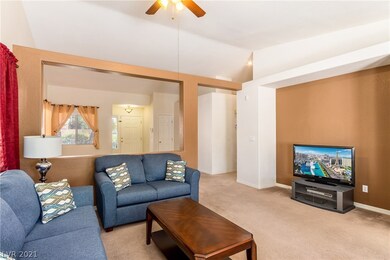 Family room. High ceiling & lots of windows.