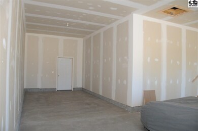 The garage is oversized and features space for 3 v