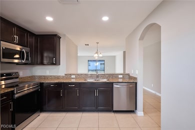 Kitchen with stainless steel appliances, light til