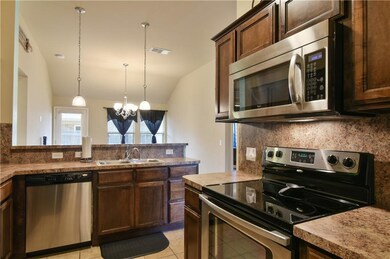Stainless steel appliances set off this sharp kitc