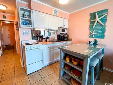 Kitchen featuring white appliances, white cabinetr