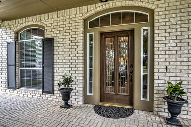 Glass leaded, wood door with side lights and transom window.