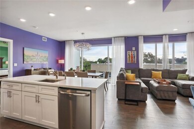 Kitchen island leads to the expansive living and dining areas
