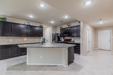 This kitchen is by far any chef’s dream! This spacious kitchen features dark stained wood cabinets, granite countertops, SS appliances, tile backsplash, recessed lighting, extended counter space, granite kitchen island with space for breakfast bar, and a walk-in pantry.
