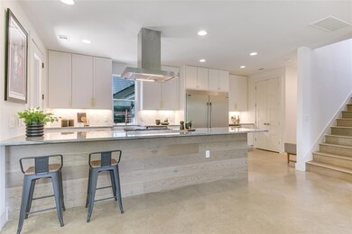 Kitchen with white cabinetry, tasteful backsplash
