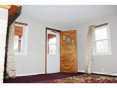 Living Room. front door leads to covered front por