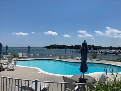View of pool with a water view and a patio