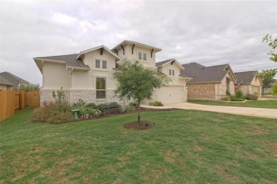 View of front facade with stone siding, concrete 