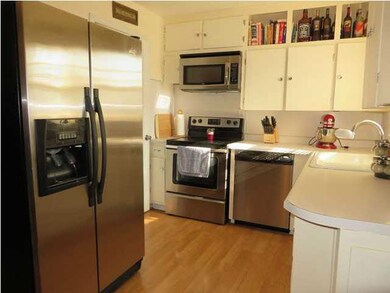 Kitchen appliances stay and separate laundry room.