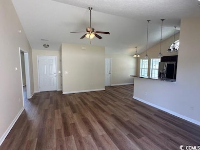 Unfurnished living room featuring baseboards, ceil