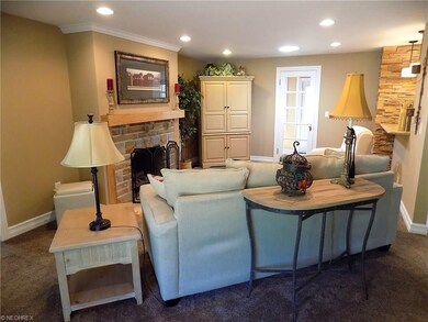 Livingroom features a stone fireplace, access to t